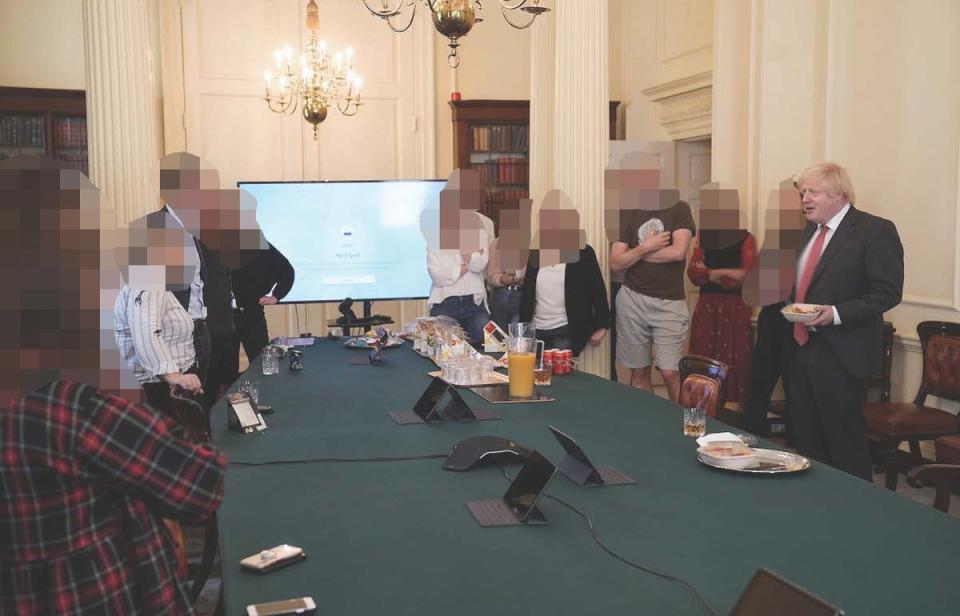 Boris Johnson (right) at a gathering celebrating his birthday - in which cake and alcohol was provided - in the Cabinet Room at 10 Downing Street on 19 July, 2020 (PA)