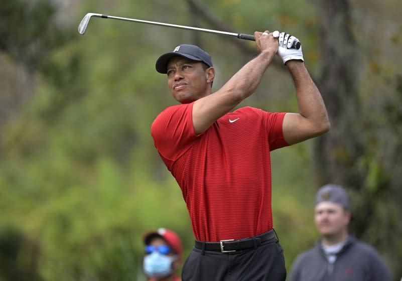 FILE - Tiger Woods watches his tee shot on the fourth hole during the final round of the PNC Championship golf tournament in Orlando, Fla., on Dec. 20, 2020. "Tiger," a two part documentary about Woods premieres Jan. 10 on HBO. (AP Photo/Phelan M. Ebenhack, File)