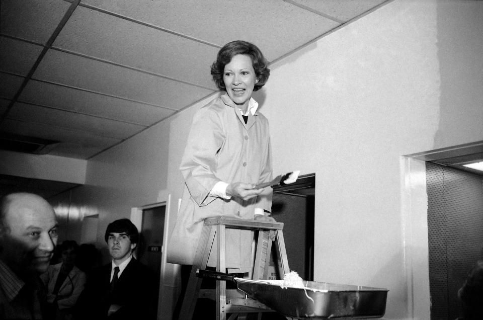 FILE - First lady Rosalynn Carter takes a brush to help out with some wall painting during her visit to District of Columbia General Hospital in Washington, May 16, 1978. Rosalynn Carter, the closest adviser to Jimmy Carter during his one term as U.S. president and their four decades thereafter as global humanitarians, died Sunday, Nov. 19, 2023. She was 96. (AP Photo/Cook, File)