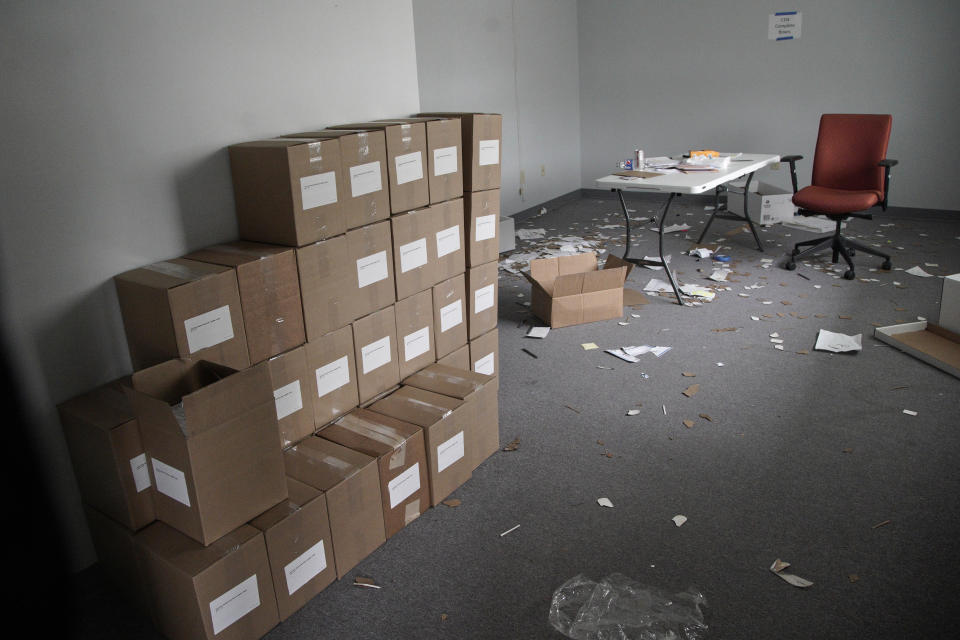 Boxes of voter registration forms are stacked at an unmanned auxiliary office of the Iowa Democratic Party headquarters in Des Moines, Iowa, Tuesday, Feb. 4, 2020. (AP Photo/Nati Harnik)