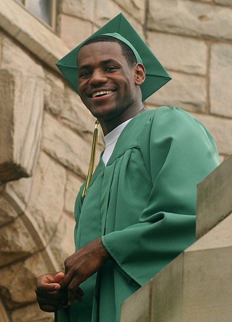 St. Vincent-St. Mary High School senior LeBron James pauses for a portrait in front of  St. Vincent's Church before the baccalaureate ceremony in 2003 in Akron.