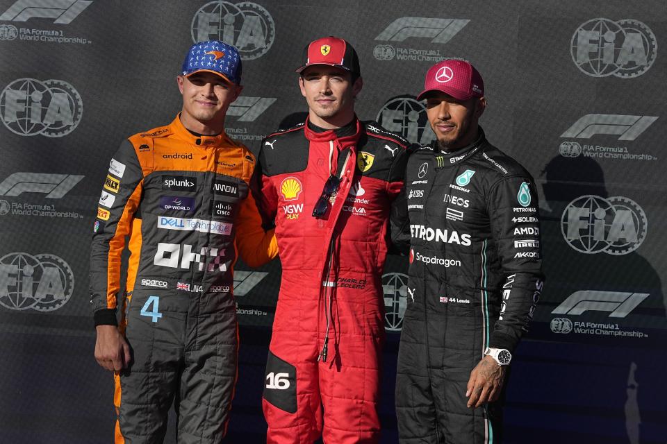 Ferrari driver Charles Leclerc, center, of Monaco, McLaren driver Lando Norris, left, of Britain and Mercedes driver Lewis Hamilton, right, also of Britain, pose for a photo after qualifications for the Formula One U.S. Grand Prix auto race at Circuit of the Americas, Friday, Oct. 20, 2023, in Austin, Texas. Leclerc is on the pole while Norris will start second and Hamilton third. (AP Photo/Darron Cummings)