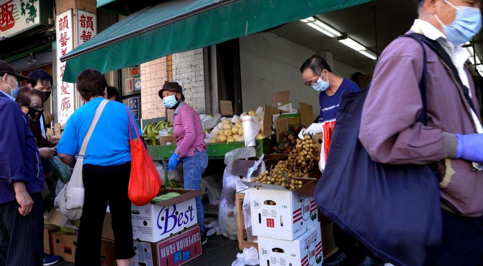 People walk and shop at the produce market in Chinatown in downtown San Francisco on Sept. 29, 2020.