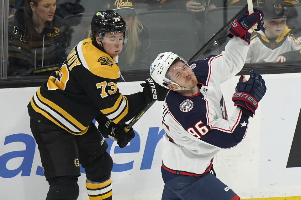 Boston Bruins defenseman Charlie McAvoy (73) and Columbus Blue Jackets center Jack Roslovic (96) collide in the first period of an NHL hockey game, Thursday, March 30, 2023, in Boston. (AP Photo/Steven Senne)