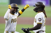 San Diego Padres' Jurickson Profar, left, celebrates with teammate Fernando Tatis Jr. after hitting a home run during the first inning of a baseball game against the Cincinnati Reds, Monday, April 29, 2024, in San Diego. (AP Photo/Gregory Bull)