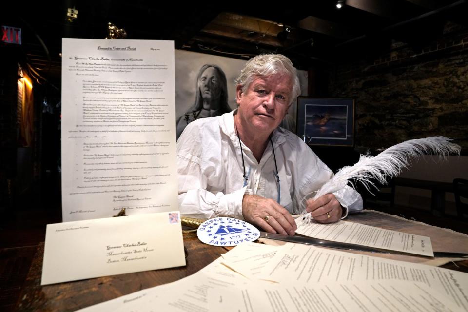 Providence restaurant owner and historian Bob Burke signs legal documents with a quill pen, trying to drum up support for the burning of the Gaspee to be recognized as the occasion of the first shot fired in anger in the American Revolution.