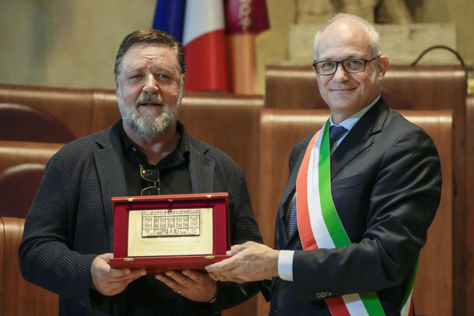 Actor Russel Crowe, left, receives the "Ambassador of Rome in the World" award from the hands of Rome's mayor Roberto Gualtieri, in Rome's Capitol Hill, Friday, Oct. 14, 2022. (AP Photo/Andrew Medichini)