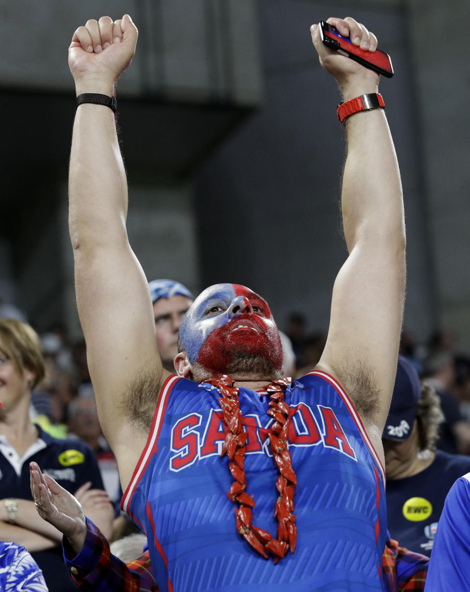 A Samoan fan gestures as he waits for the start of the Rugby World Cup Pool A game at Kobe Misaki Stadium between Scotland and Samoa in Kobe City, Japan, Monday, Sept. 30, 2019. (AP Photo/Aaron Favila)