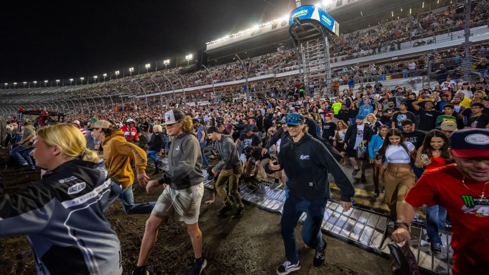 daytona supercross crowd storm course after the conclusion of the event