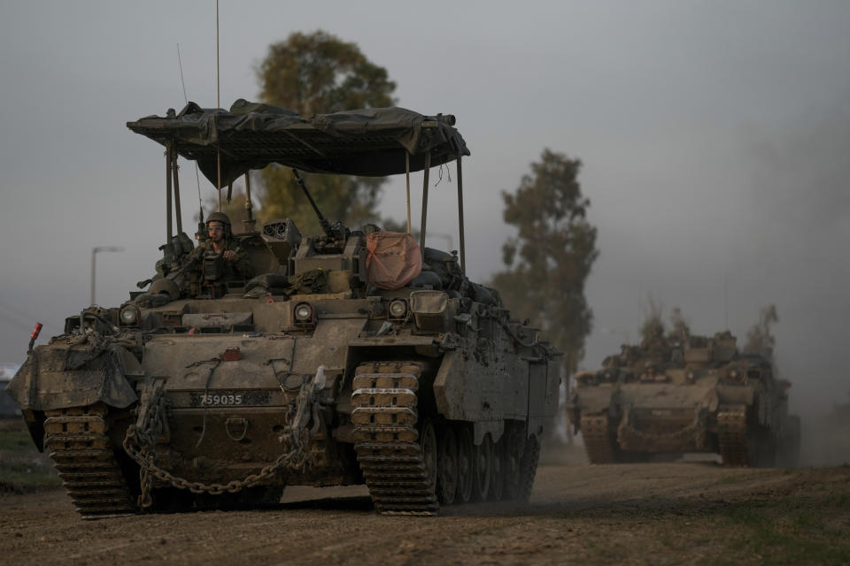 A convoy of Israeli army armoured personnel carriers (APC) moves near the Israeli-Gaza border, in southern Israel, Monday, Dec. 25, 2023. The army is battling Palestinian militants across Gaza in the war ignited by Hamas' Oct. 7 attack into Israel. (AP Photo/Leo Correa)