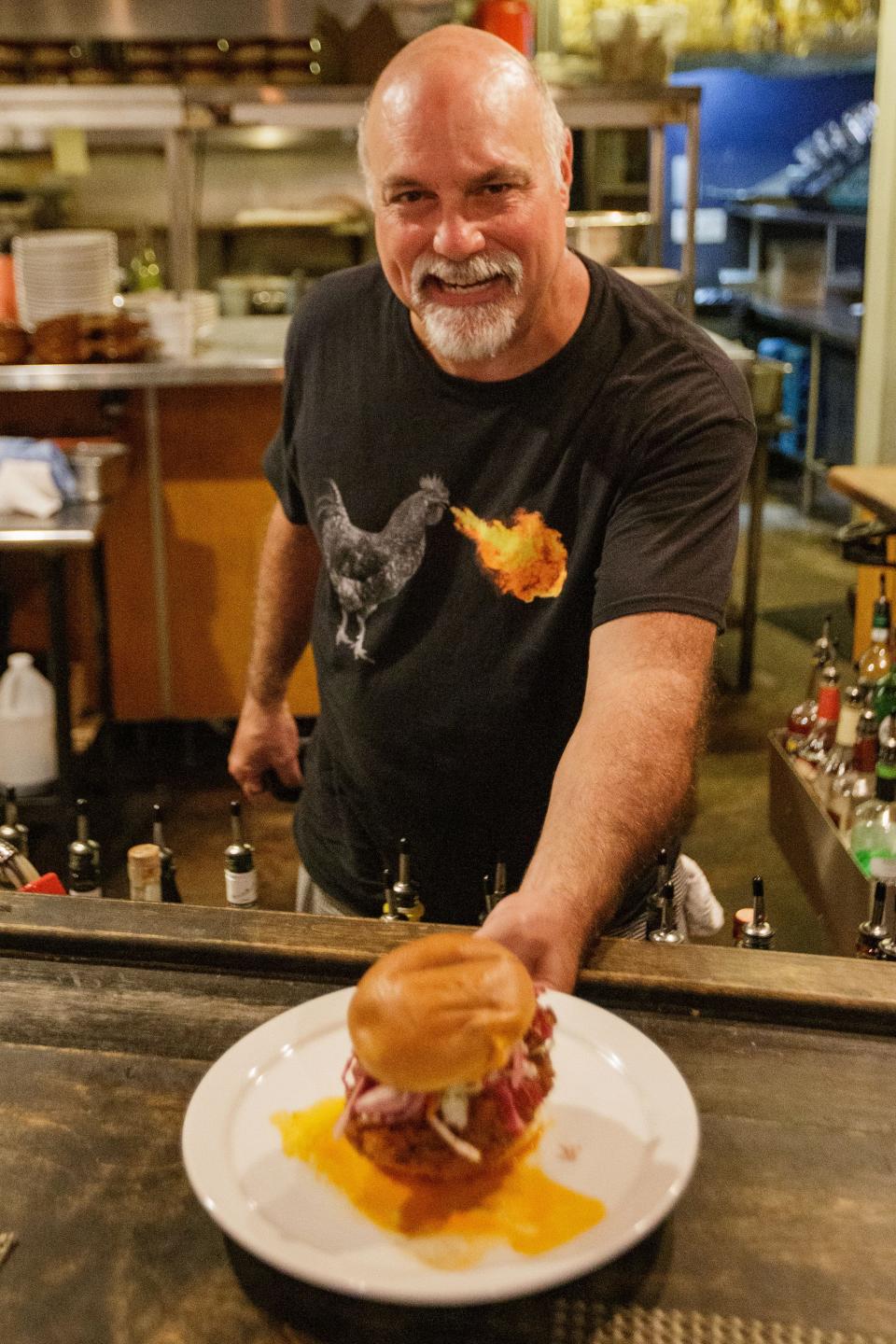 Kevin Stout, owner and executive chef at Food Glorious Food, poses with the Hot Birdie chicken sandwich Wednesday, Sept. 15, 2021. Stout will serve the sandwich as well as several others at his new restaurant Hot Birdie's Chicken, which is set to open later this year. 