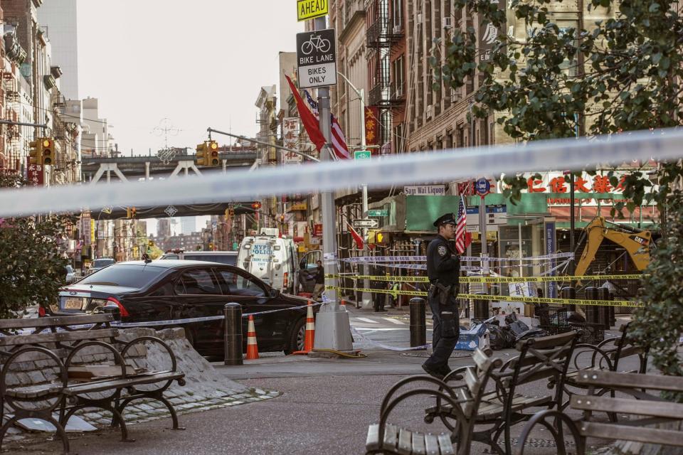 New York Police Department officers investigate the scene of an attack in Manhattan's Chinatown neighborhood, Saturday, Oct. 5, 2019 in New York.