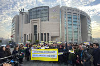 Turkish and international human rights activists speak to the media before the trial of the Amnesty International's former Turkey chairman and 10 other activists, in Istanbul, Wednesday, Feb. 19. 2020. A court in Istanbul will hand down verdicts for defendants in the closely-watched trial on charges of belonging to or aiding terror groups. The case against activists heightened concerns about Turkey's treatment of human rights defenders. (AP Photo)