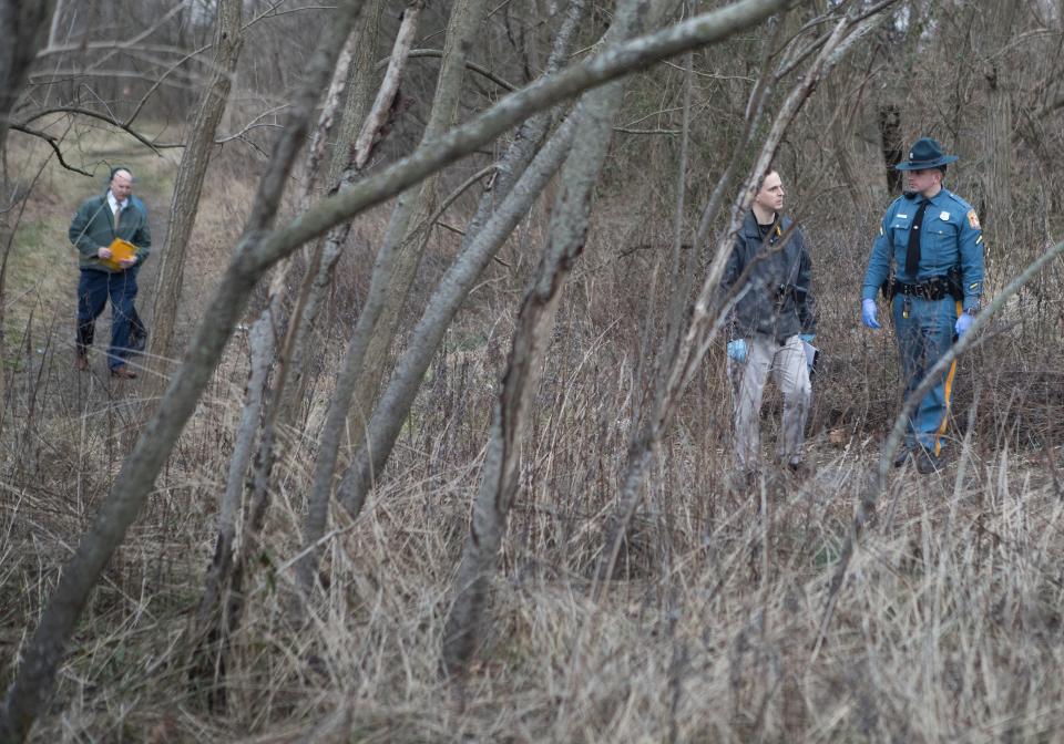 Delaware State Police work a scene where four people were found dead at a homeless camp Tuesday evening in Stanton.