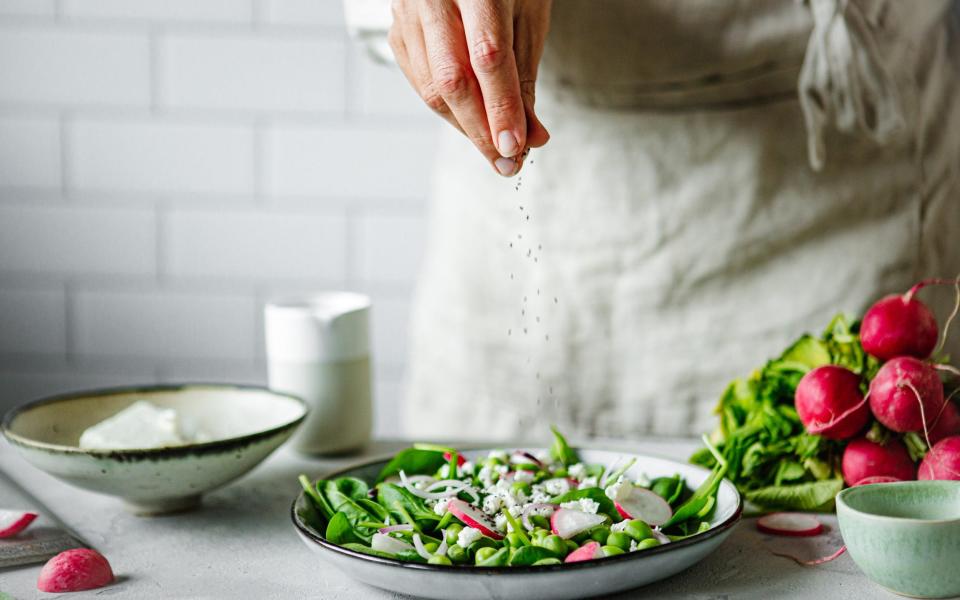 Woman sprinkling salt