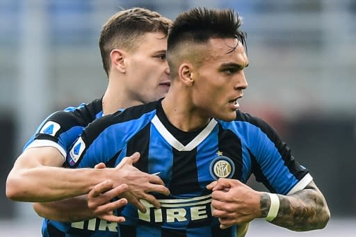 Inter Milan's Nicolo Barella (L) restrains furious teammate Lautaro Martinez who saw red at the San Siro