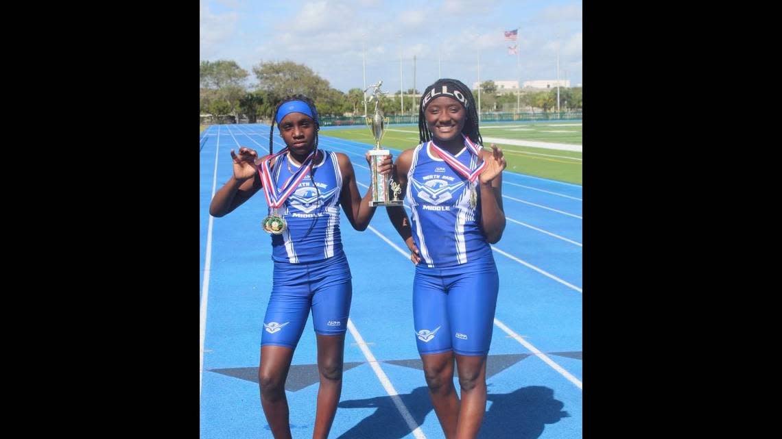Rell’Niyah Jones, left, and Javariah Mills celebrate their wins at the Larry Wooten Middle Schools Track and Field Invitational at Traz Powell Stadium.