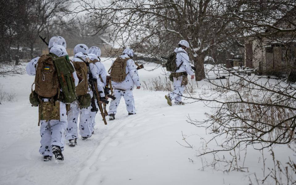 Ukrainian soldiers wearing white camouflage for fighting in snow complete a training mission - Scott Peterson/Getty Images Europe