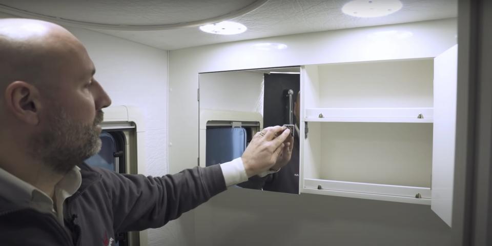 a person opening the vanity of the Wingamm Oasi 540