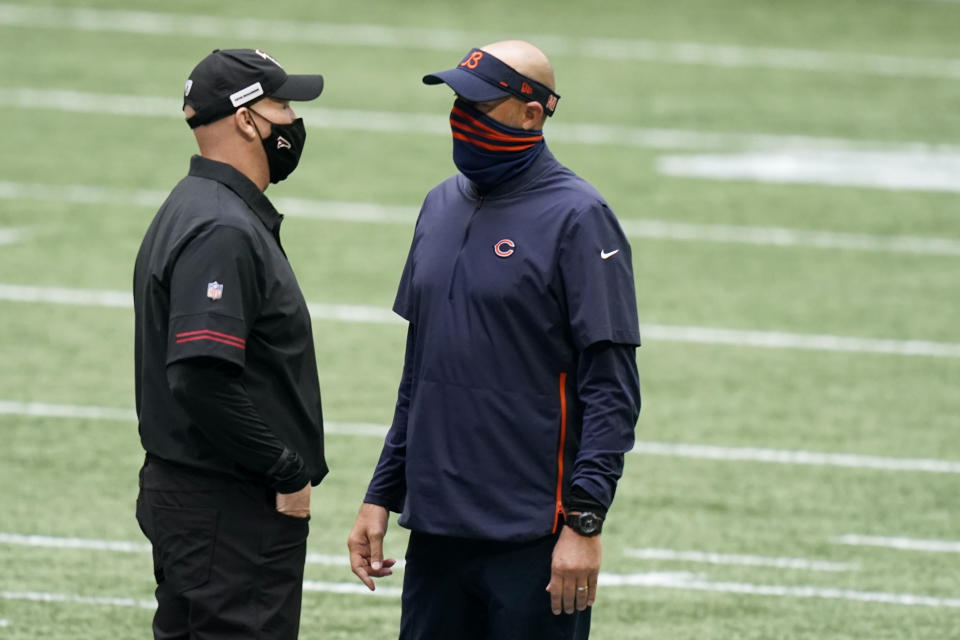 Chicago Bears head coach Matt Nagy and Atlanta Falcons head coach Dan Quinn speak at midfield before the first half of an NFL football game, Sunday, Sept. 27, 2020, in Atlanta. (AP Photo/Brynn Anderson)