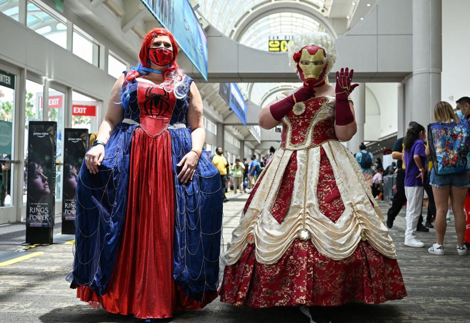 Spider-Man and Iron Man inspired princess cosplayers pose in the convention center lobby during Comic-Con International 2022 on July 22, 2022 in San Diego, California.