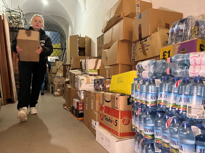 Ukrainian refugee Luidmyla Nazarova helps deliver humanitarian aid to St. George's Cathedral, in Lviv