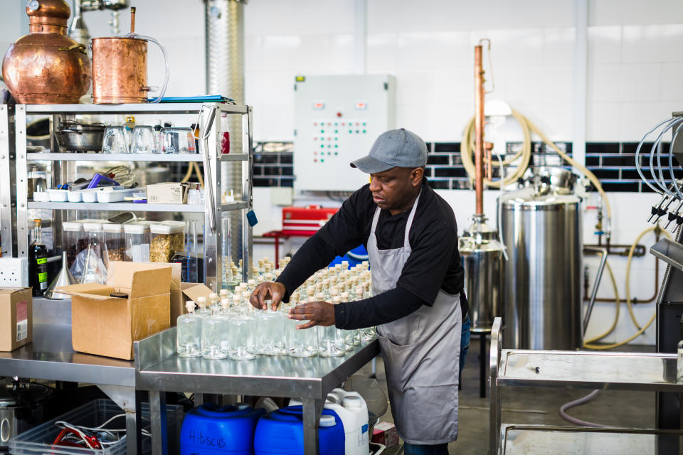 Worker in a small scale gin distillery business