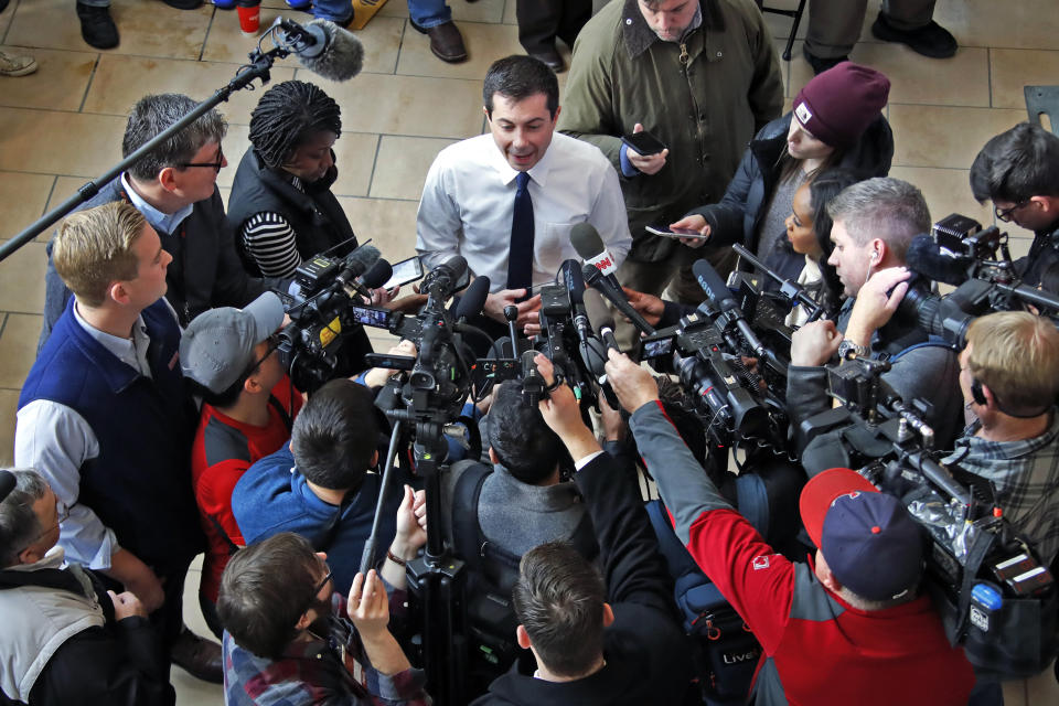 Democratic presidential candidate former South Bend, Ind., Mayor Pete Buttigieg, top center, talks me media following a town hall meeting at the University of Dubuque in Dubuque, Iowa, Wednesday, Jan. 22, 2020. (AP Photo/Gene J. Puskar)