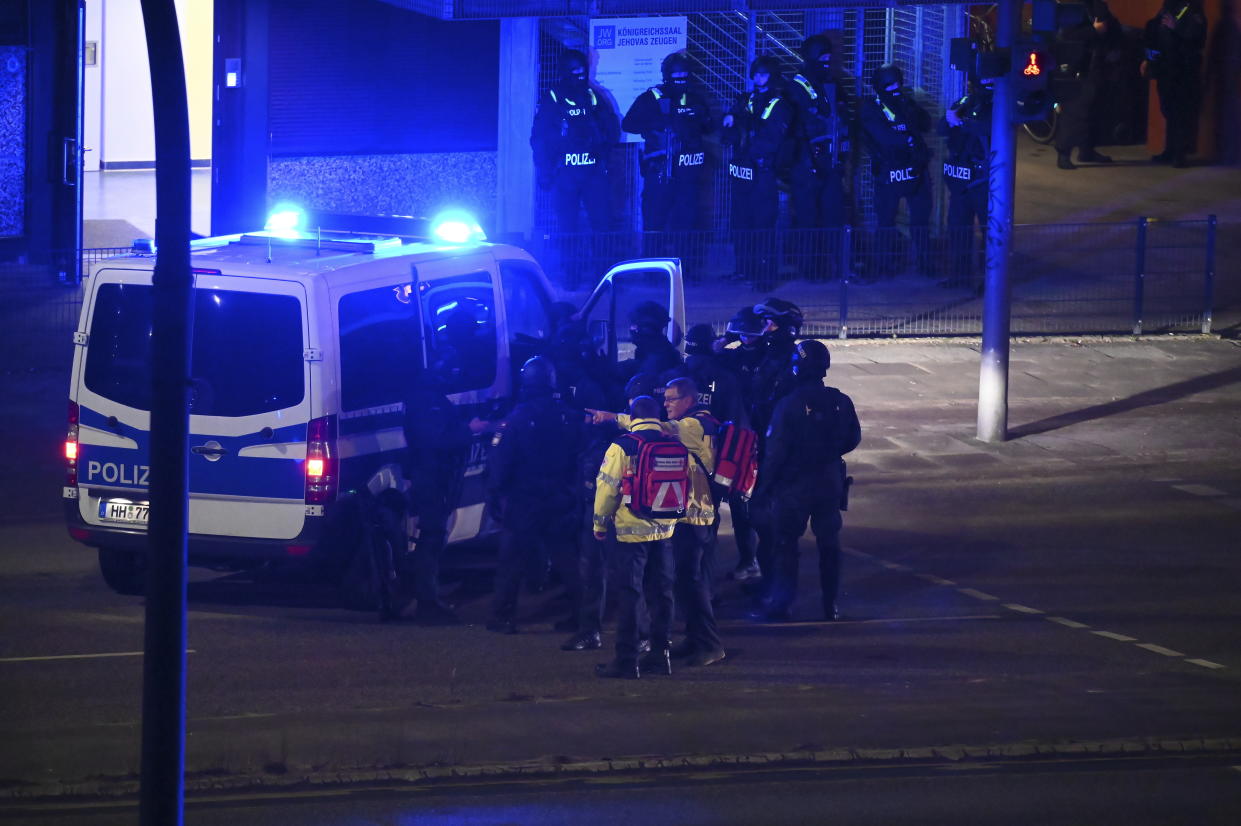 Armed police officers near the scene of a shooting in Hamburg, Germany on Thursday March 9, 2023 after one or more people opened fire in a church. The Hamburg city government says the shooting took place in the Gross Borstel district on Thursday evening. (Jonas Walzberg/dpa via AP)