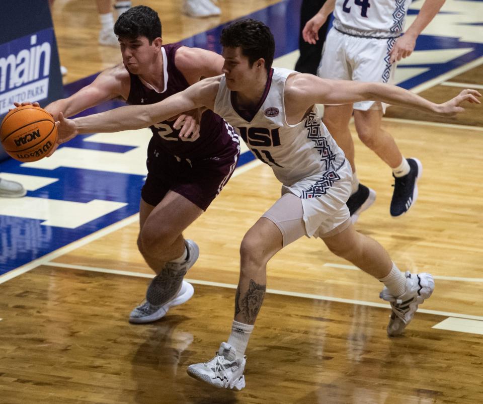 Southern Indiana’s Jack Mielke (11) and Southern Illinois’ Troy D’Amiko (23) battle for control of the ball as the University of Southern Indiana Screaming Eagles play the Southern Illinois Salukis at Screaming Eagles Arena in Evansville, Ind., Sunday afternoon, Nov. 13, 2022. 