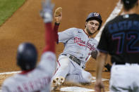 Washington Nationals' Trea Turner slides into home to score on a sacrifice fly by Kurt Suzuki during the first inning of the second game of the team's baseball doubleheader against the Miami Marlins, Friday, Sept. 18, 2020, in Miami. (AP Photo/Wilfredo Lee)