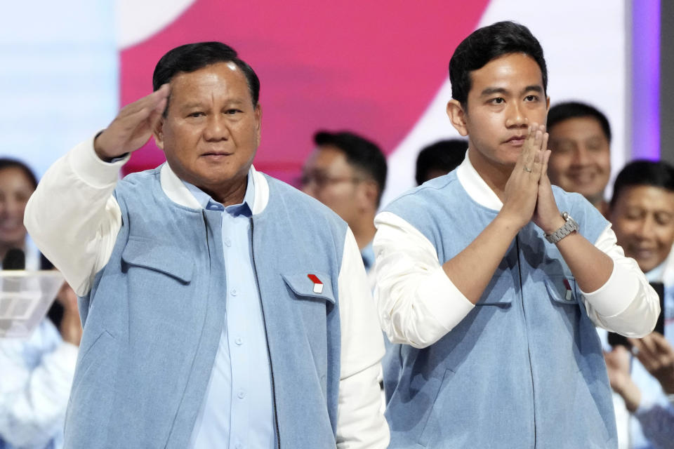 FILE - Presidential candidate Prabowo Subianto, left, and his running mate Gibran Rakabuming Raka, the eldest son of Indonesian President Joko Widodo, arrive for the fifth presidential candidates' debate in Jakarta, Indonesia Sunday, Feb. 4, 2024. Indonesia, the world's third-largest democracy, will open its polls on Wednesday to nearly 205 million eligible voters in presidential and legislative elections, the fifth since Southeast Asia's largest economy began democratic reforms in 1998. (AP Photo/Tatan Syuflana, File)