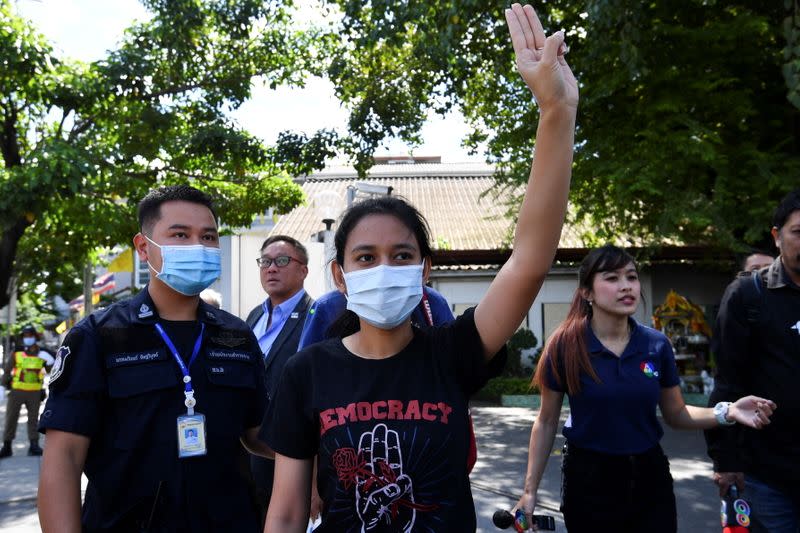 One of Thailand's protest leaders, Patsaravalee "Mind" Tanakitvibulpon makes a three-finger salute after she was freed on bail, in Bangkok