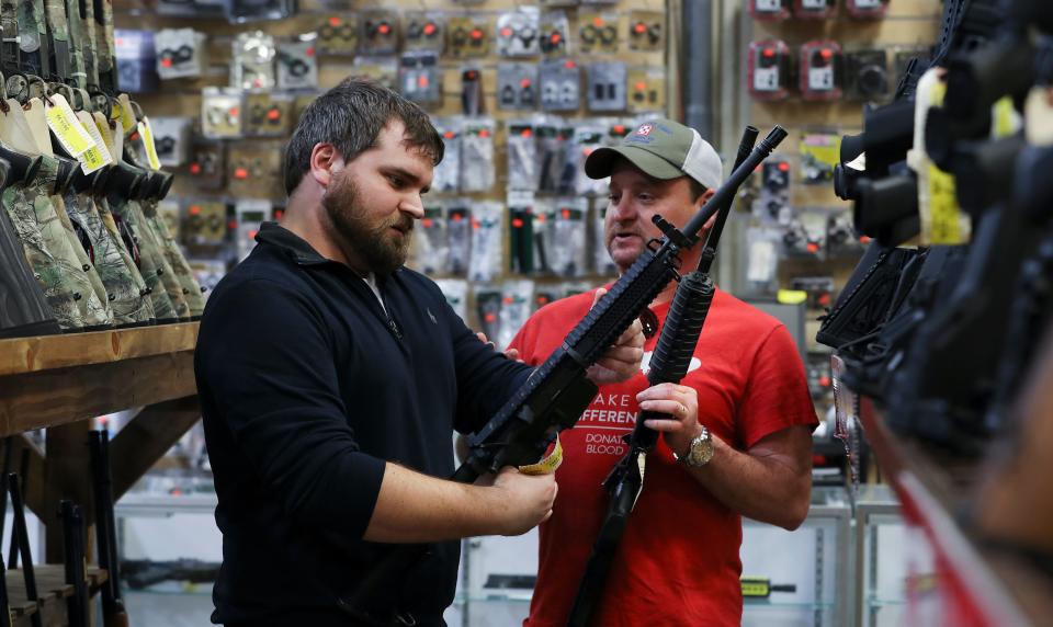Chaz Jewell, 31, left, and Shea Grimsley, 46, of Taylor County, shopped AR-15 rifles at the Kentucky Gun Co. in Bardstown, Ky. on Mar. 18, 2020.