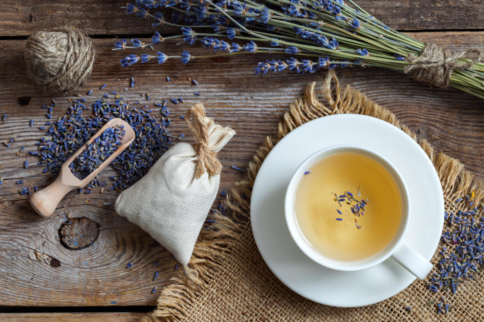 Bunch of lavender flowers, sachets filled with dried lavender and healthy tea. Top view. Flat lay.