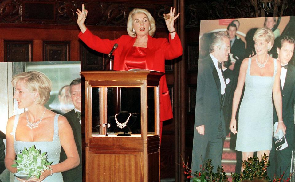 NEW YORK, UNITED STATES:  Auctioneer Lorna Kelley of Guernsey's gives fair warning for final bids before dropping the gavel on the sale of the Diana, Princess of Wales Swan Lake Suite necklace and earrings 16 December, 1999 at the Armory in New York, NY.  The suite sold for $525,000 before inclusion of commission to a buyer on the telephone in an auction that saw only two bids.      AFP PHOTO/Matt CAMPBELL (Photo credit should read MATT CAMPBELL/AFP via Getty Images)