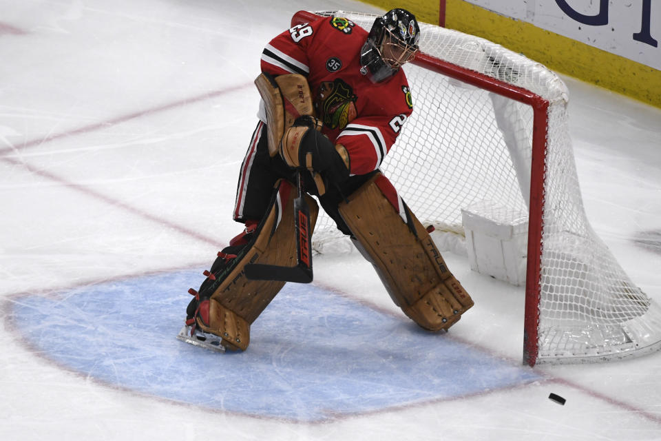 Chicago Blackhawks goaltender Marc-Andre Fleury (29) flips the puck out of the goal after the Tampa Bay Lightning scored during the third period of an NHL hockey game, Sunday, March 6, 2022, in Chicago. (AP Photo/Matt Marton)