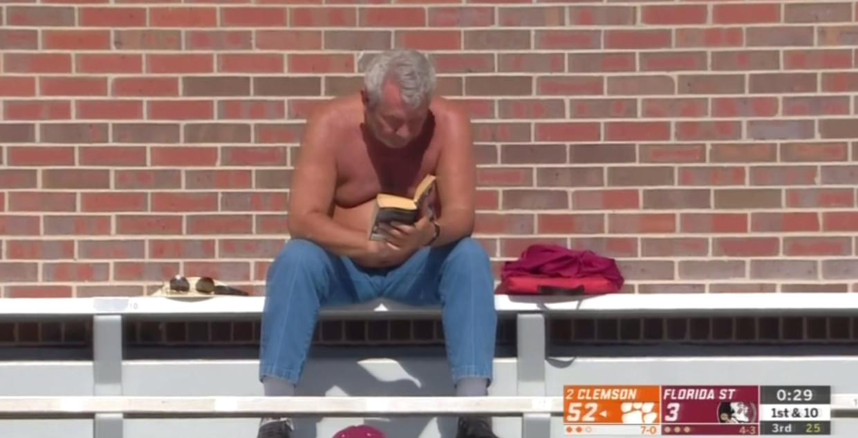 One Florida State fan turned to his book during the Seminoles’ 49-point home loss to Clemson on Saturday. (ABC)