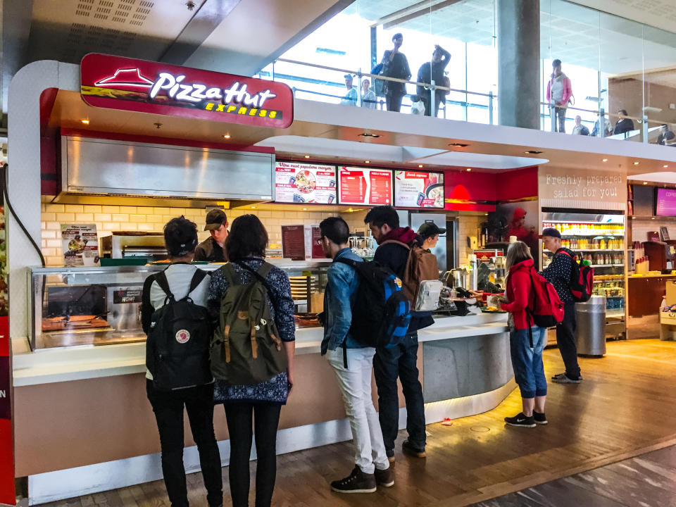 Oslo, Norway - July 26, 2015: People buying food at Pizza Hut Express, Oslo Airport