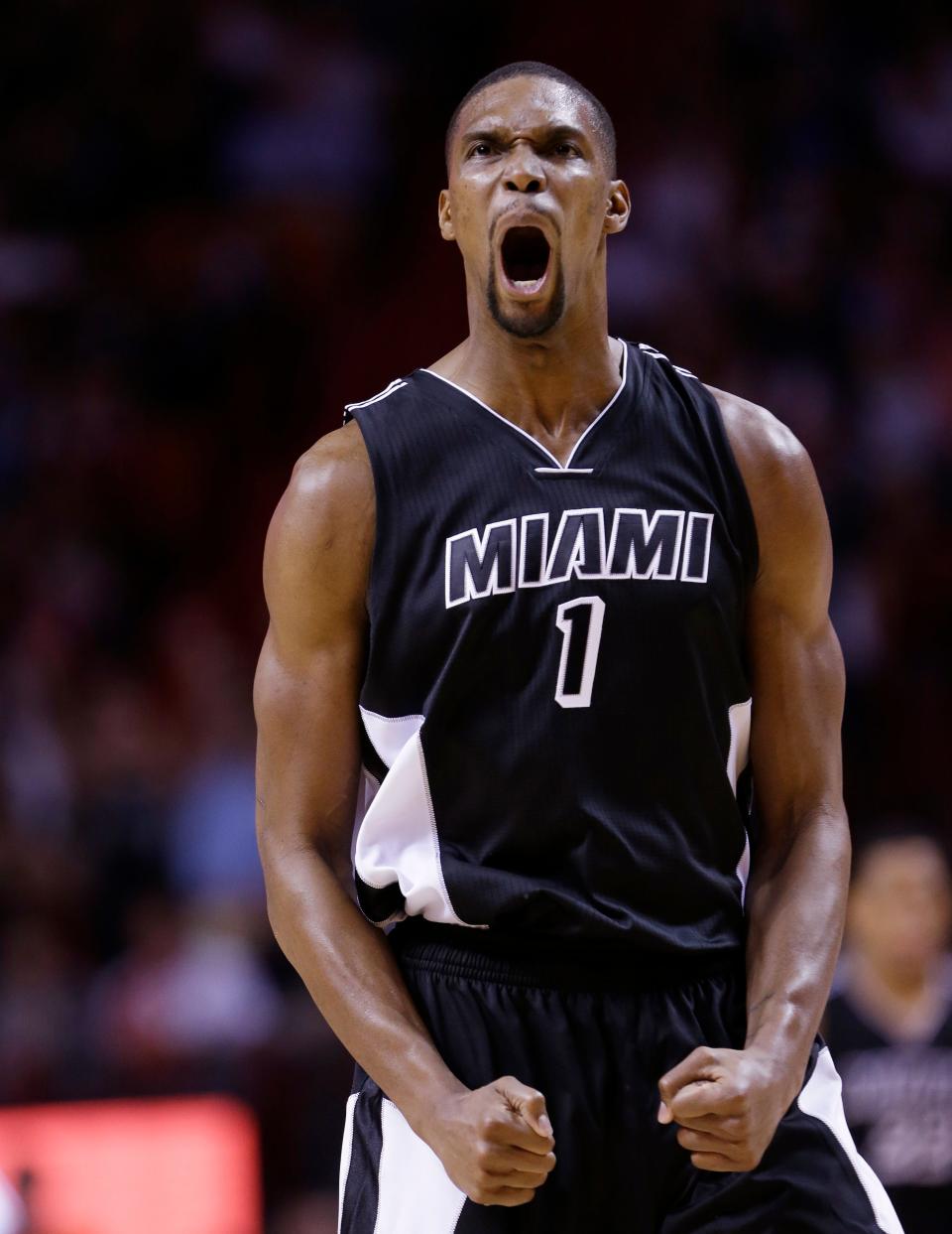 Miami Heat center Chris Bosh celebrates after scoring during the second half of an NBA basketball game against the New York Knicks, Monday, Feb. 9, 2015, in Miami. Bosh scored 32 points in the game as the Heat defeated the Knicks 109-95.