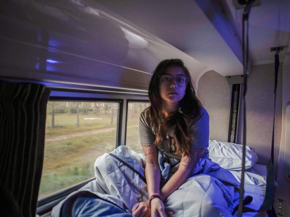 The author sits in the top bunk in a roomette.