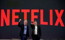 FILE PHOTO: Reed Hastings, co-founder and CEO of Netflix, and Ted Sarandos, Netflix chief content officer, pose for photographs during a news conference in Seoul