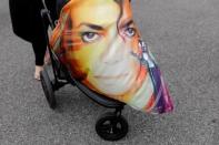 A baby stroller is covered with a Michale Jackson sheet as fans gather at Forest Lawn Cemetery ten years after the death of child star turned King of Pop, Michael Jackson, in Glendale, California