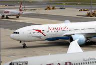 Belarusian Olympic sprinter Krystsina Tsimanouskaya has assuringly landed in an Austrian airline aircraft at Schwechat International Airport in Vienna Austria, Wednesday, Aug. 4, 2021. Tsimanouskaya plans to seek refuge in Europe after accusing team officials of trying to force her to leave the Tokyo Games early. (AP Photo/Lisa Leutner)