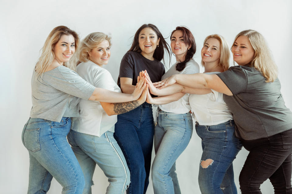 Young caucasian women in casual clothes having fun together. Friends posing on white background and laughting, looks happy, well-kept. Bodypositive, feminism, loving themself, beauty concept.