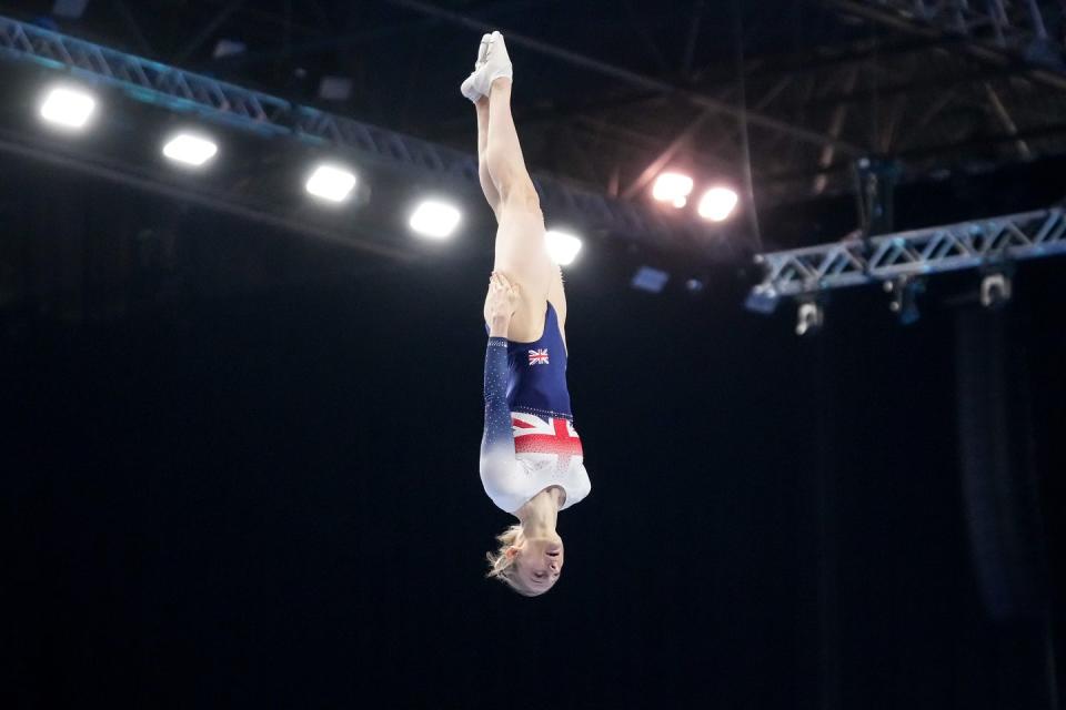 olympic gymnast bryony page doing an upside down flip on a trampoline