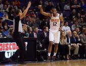 Nov 14, 2018; Phoenix, AZ, USA; Phoenix Suns forward TJ Warren (12) reacts after making a three point shot against the San Antonio Spurs during the first half at Talking Stick Resort Arena. Mandatory Credit: Joe Camporeale-USA TODAY Sports