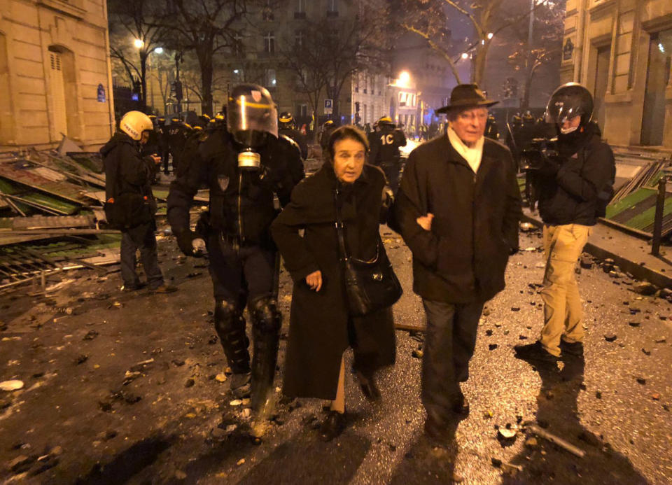 French riot police evacuate an elderly couple near the Arc de Triomphe during clashes with protesters wearing yellow vests, a symbol of a French drivers’ protest against higher diesel taxes, in Paris, Dec. 1, 2018. (Photo: Lucien Libert/Reuters)