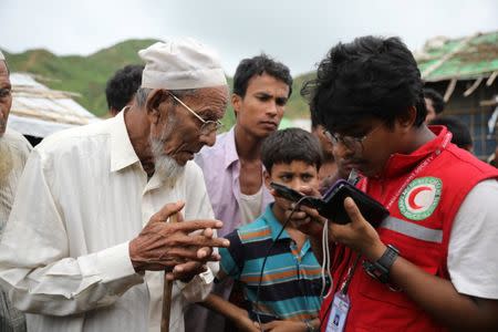 Oli Mian, a Rohingya refugee who has found his son in Buthidaung prison in Myanmar through trace message request program of Bangladesh Red Crescent Society, is seen at a camp in Cox's Bazar, Bangladesh, July 3, 2018. Picture taken July 3, 2018. REUTERS/Mohammad Ponir Hossain