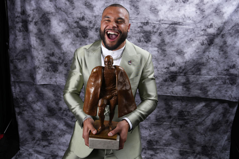 Walter Payton Player of the Year Award winner, Dallas Cowboys' Dak Prescott, poses for a photo during the NFL Honors award show ahead of the Super Bowl 57 football game, Thursday, Feb. 9, 2023, in Phoenix. (AP Photo/Ross D. Franklin)
